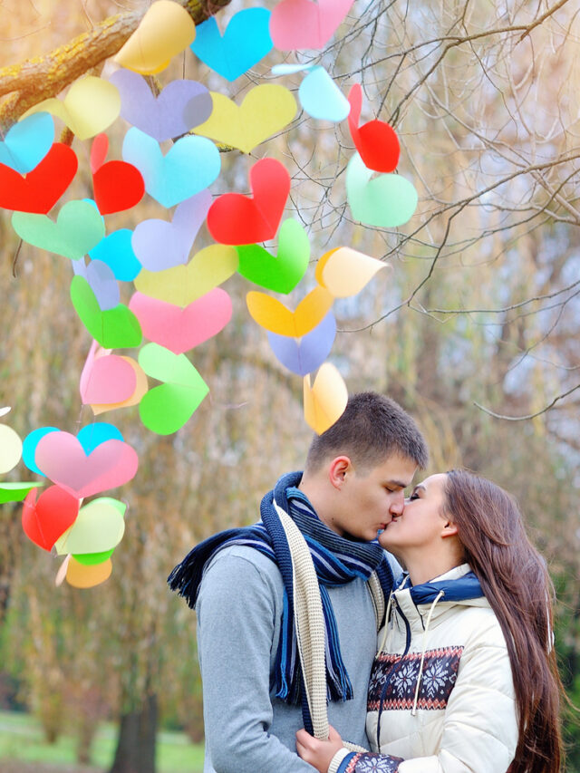 man and woman kiss on Valentine's Day, the tree is decorated wit